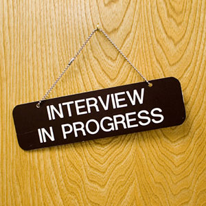 A sign on a door that says interview in progress